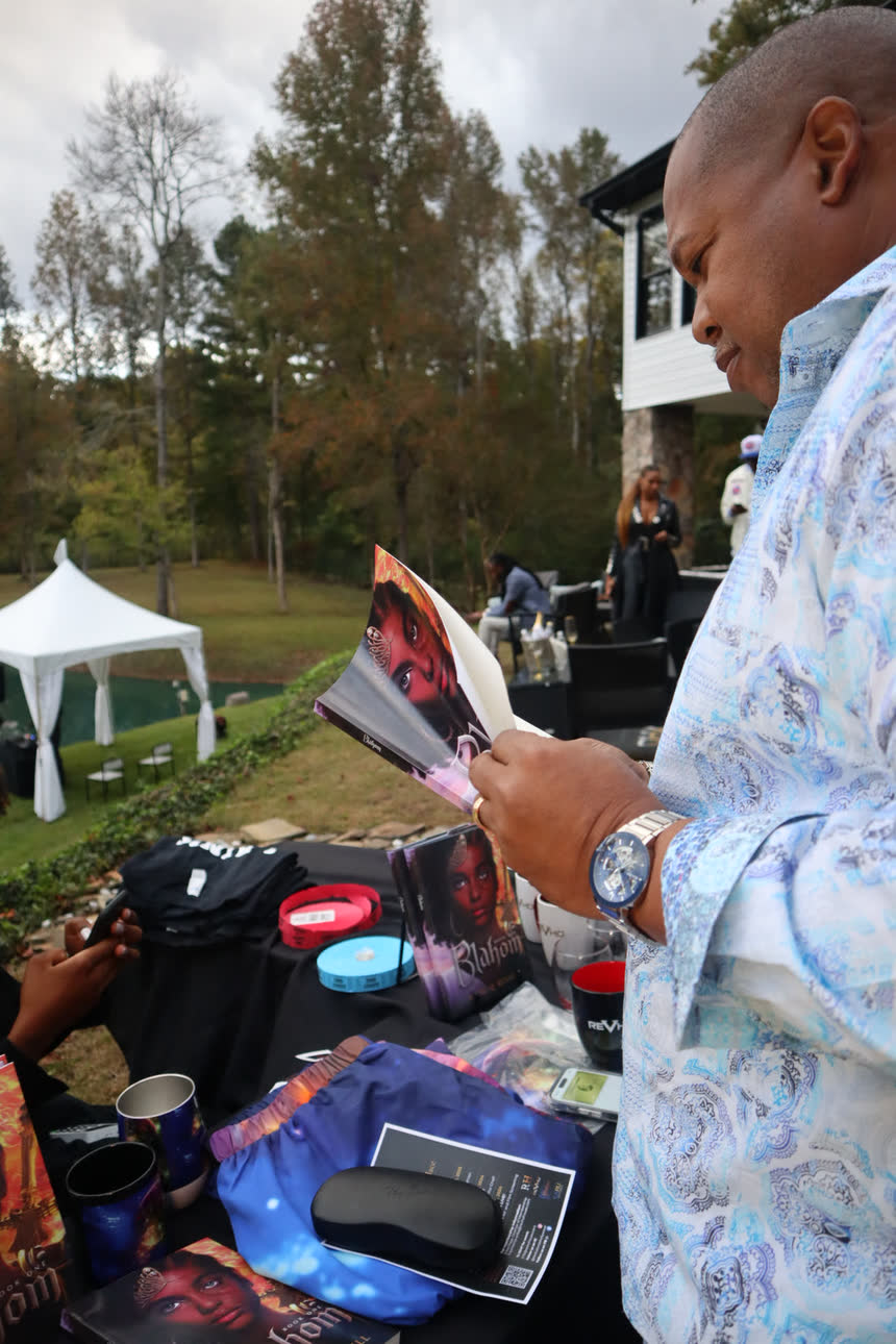 A reader with Book I, merchandise table visible.